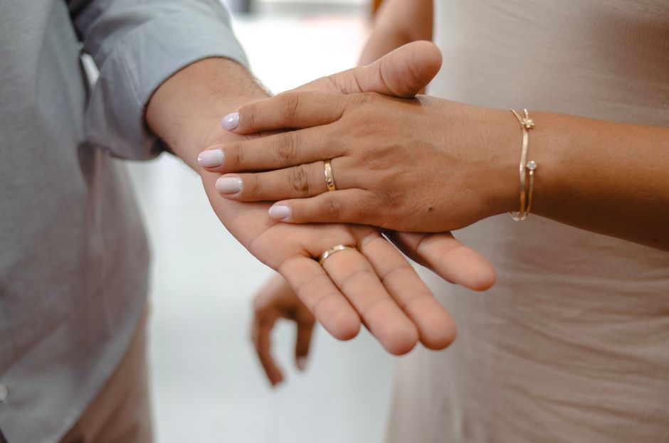 Couple engagement rings hand