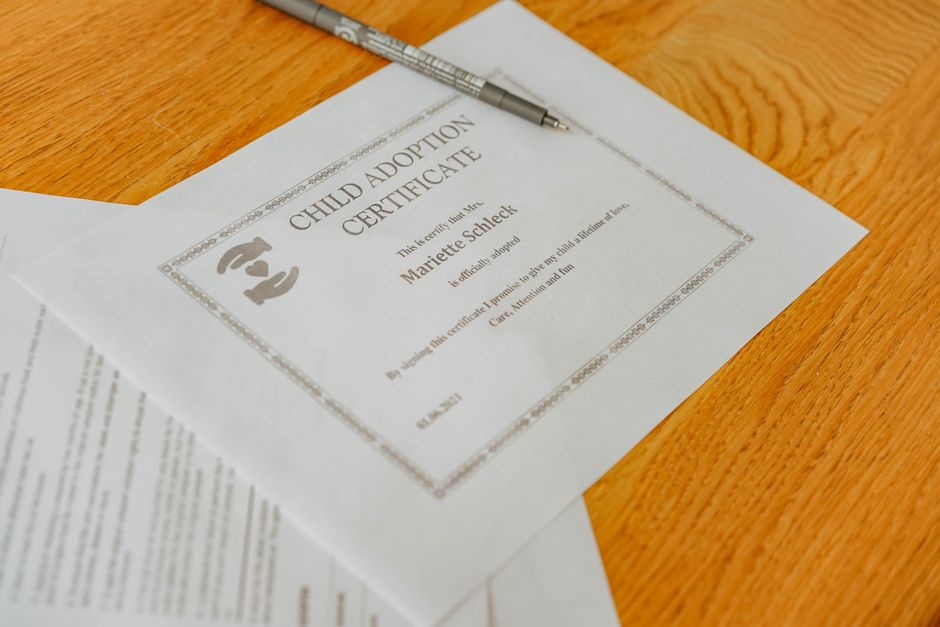 Person filling a form with a pen